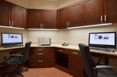a office with two computers on a desk with chairs at Hampton Inn & Suites East Hartford in East Hartford