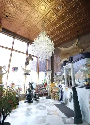 a large room with a chandelier and a living room at Paris Suites Hotel in Queens