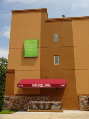 a building with a sign for a sheridan hotel at Sheridan Hotel in Bronx