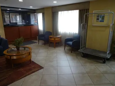 a waiting room in a hospital with chairs and a table at Sheridan Hotel in Bronx