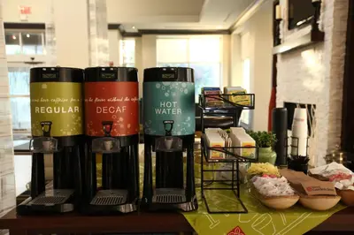 a table with a bunch of products on it at Hilton Garden Inn Westbury in Westbury