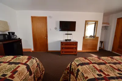 a hotel room with two beds and a television at Williamstown Motel in Williamstown