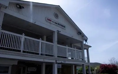 a large building with a balcony on the side of it at Inn on the Hudson in Peekskill