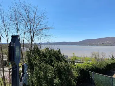 a view of a large body of water with a fence at Inn on the Hudson in Peekskill