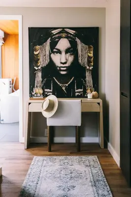 a room with a desk with a painting on the wall at CODA Williamsburg in Brooklyn