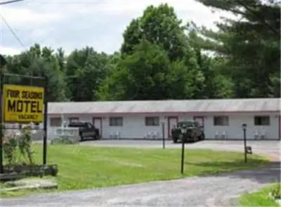a motel with a sign in front of a building at Four Seasons Motel in Catskill