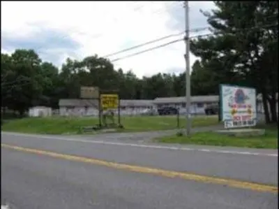 a road with signs on the side of the road at Four Seasons Motel in Catskill