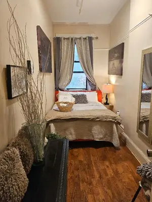 a bedroom with a bed and a window at Harlem Brownstone in New York