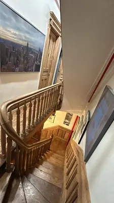 a wooden staircase in a building with a large window at Harlem Brownstone in New York