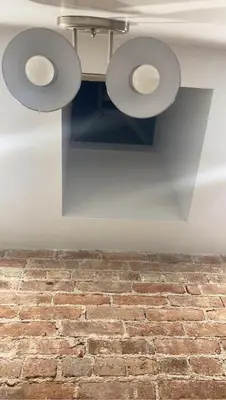 a ceiling with three lights on a brick wall at Harlem Brownstone in New York