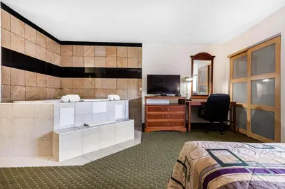 a hotel room with a bed and a desk at Quality Inn & Suites Binghamton Vestal in Binghamton