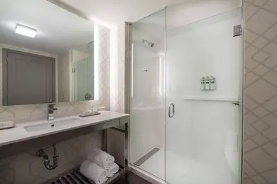 a bathroom with a shower and a sink at Residence Inn by Marriott Weehawken in Weehawken