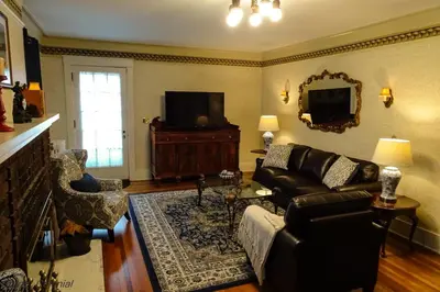 a living room with a couch and a tv at Grand Colonial Bed and Breakfast in Herkimer