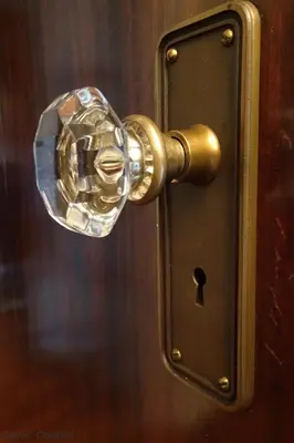 a bronze door knob on a wooden door at Grand Colonial Bed and Breakfast in Herkimer