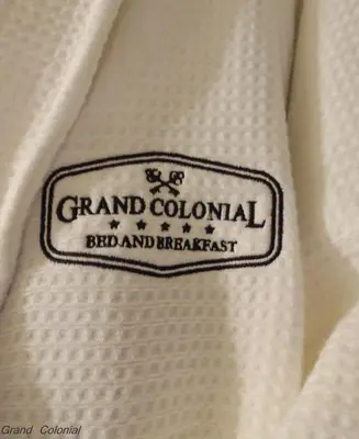 a close up of a label on a white tie at Grand Colonial Bed and Breakfast in Herkimer