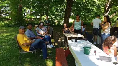 a group of people sitting around in a park at Catskill Motor Court in Catskill