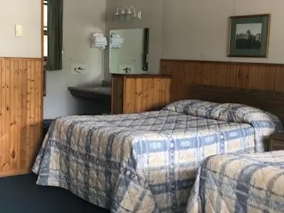 a hotel room with two beds and a mirror at Catskill Motor Court in Catskill