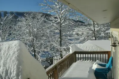 a snow covered balcony with a view of a mountain at Townhouse W Private Deck & Mt View in Windham