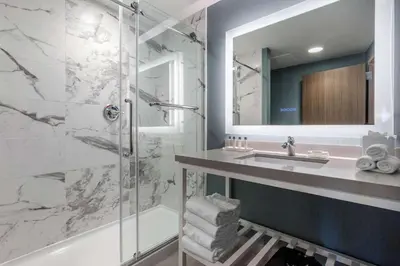 a bathroom with a sink and a shower at Cambria Hotel West Orange in West Orange