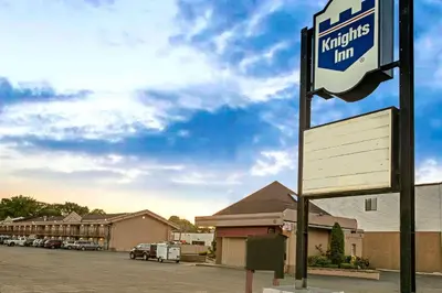 a sign for a krispy klicks inn in a parking lot at Knights Inn South Hackensasck in South Hackensack
