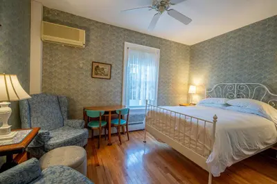 a bedroom with a bed and a living room at Albergo Allegria Hotel & Breakfast Restaurant in Windham