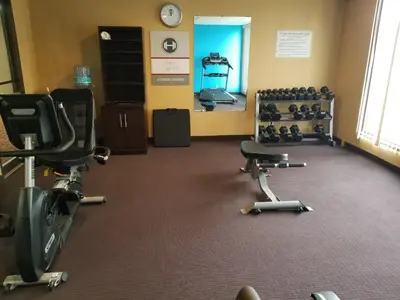a gym with exercise equipment in a room at Fairmount Inn & Suites - Stroudsburg, Poconos in Delaware Water Gap