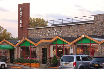 a building with cars parked in front of it at Tides Inn at Stehli Beach in Locust Valley