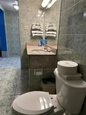 a bathroom with a toilet and a sink at Tides Inn at Stehli Beach in Locust Valley