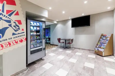 a soda shop with a table and a television at Super 8 by Wyndham Schenectady/Albany Area in Schenectady