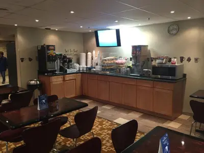a restaurant with a bar with tables and chairs at Super 8 by Wyndham Schenectady/Albany Area in Schenectady