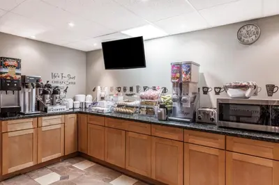 a kitchen with a counter with a coffee shop at Super 8 by Wyndham Schenectady/Albany Area in Schenectady