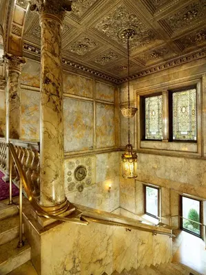a large room with a staircase in a building at Lotte New York Palace in New York