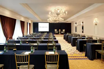 a conference room with tables and chairs and a screen at Lotte New York Palace in New York