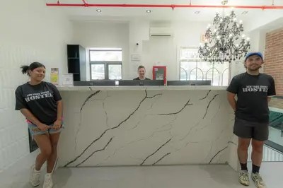 a man and a woman standing in front of a counter at NY Moore Hostel in Brooklyn