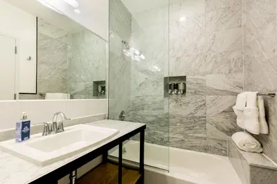 a bathroom with a sink and a shower at The Box House Hotel in Brooklyn