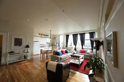 a living room with a couch and a table at The Box House Hotel in Brooklyn