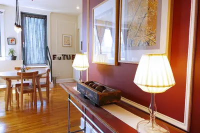 a living room with two lamps on a table at The Box House Hotel in Brooklyn