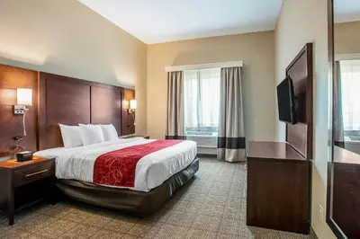 a hotel room with a bed and a flat screen tv at Comfort Suites Fishkill near Interstate 84 in Fishkill