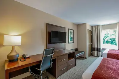 a hotel room with a desk and a bed at Comfort Suites Fishkill near Interstate 84 in Fishkill