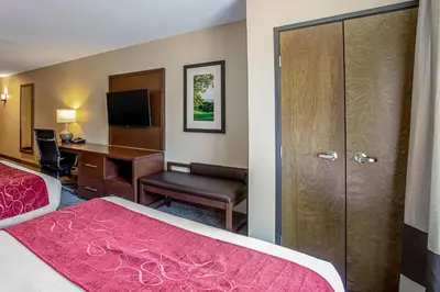 a hotel room with a bedroom with a desk and a bed at Comfort Suites Fishkill near Interstate 84 in Fishkill