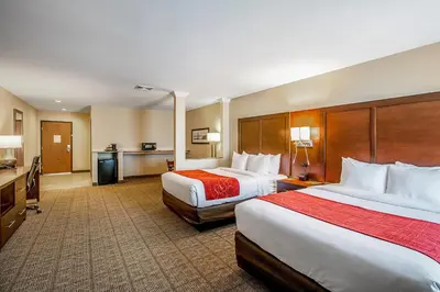 a hotel room with two beds and a kitchen at Comfort Suites Fishkill near Interstate 84 in Fishkill
