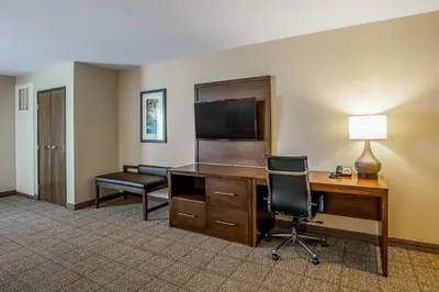 a hotel room with a desk with a computer and a chair at Comfort Suites Fishkill near Interstate 84 in Fishkill