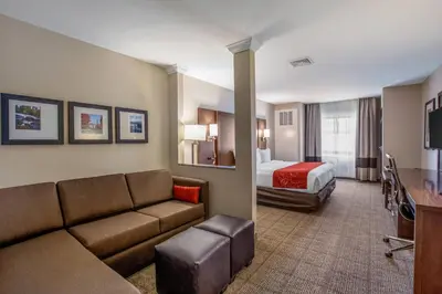 a hotel room with a couch and a bed at Comfort Suites Fishkill near Interstate 84 in Fishkill
