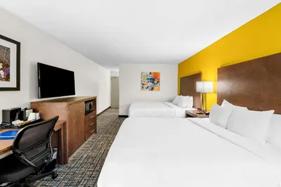 a hotel room with two beds and a desk at Best Western Inn at Ramsey in Ramsey