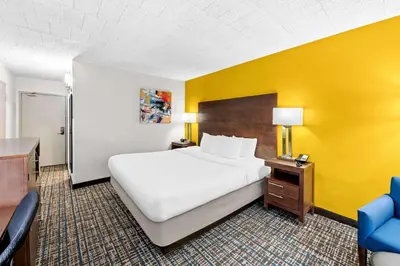 a hotel room with a bed and a yellow wall at Best Western Inn at Ramsey in Ramsey