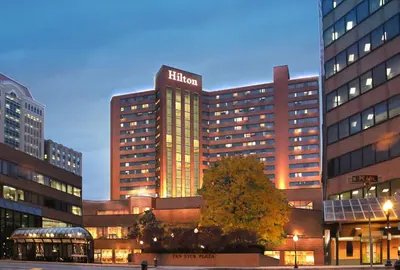 a lit up hotel building in a city at night at Hilton Albany in Albany