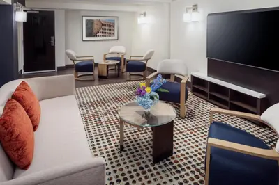 a living room with a couch and a flat screen tv at Hilton Albany in Albany