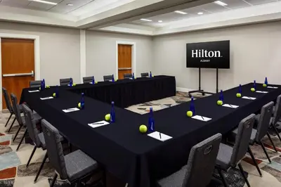a conference room with a long table with tennis balls on it at Hilton Albany in Albany
