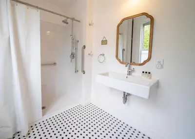 a white bathroom with a sink and a mirror at Twin Gables of Woodstock in Woodstock