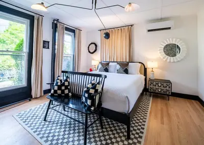 a bedroom with a bed and a table at Twin Gables of Woodstock in Woodstock